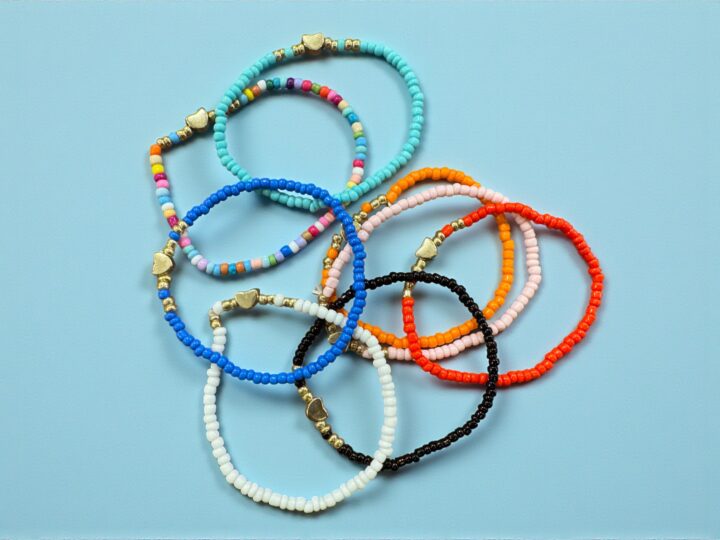 Colorful beaded bracelets set for school favors on blue background
