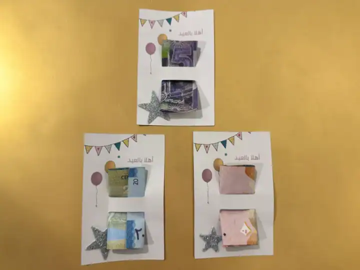 Set of party Eidiyah money cards with bunting and balloons, cash slots, and glitter star